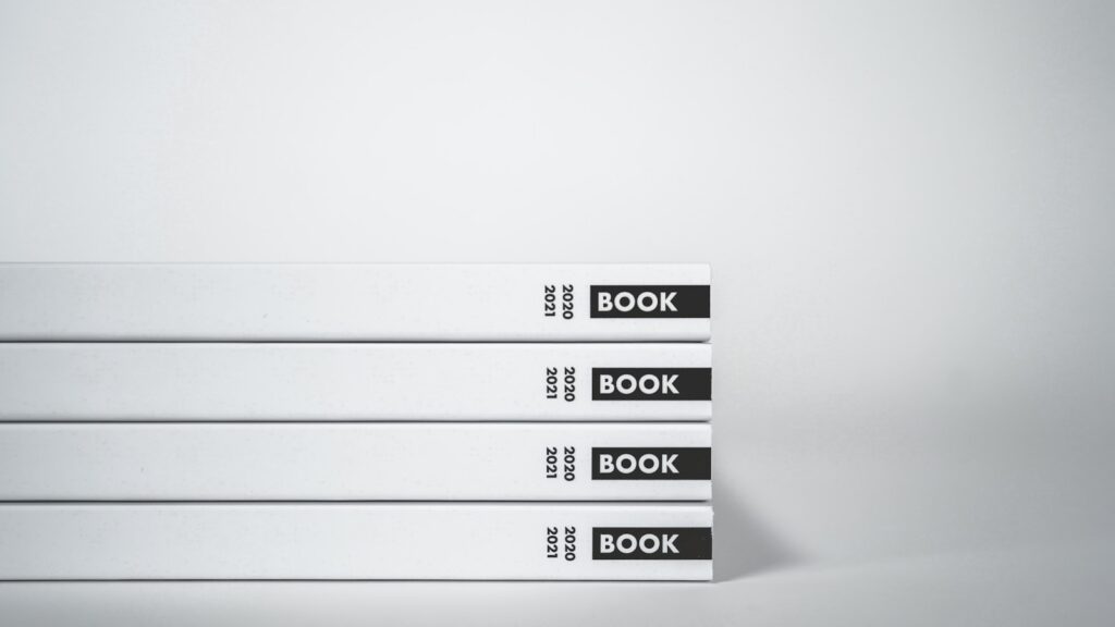 Stacked white- and black-covered books